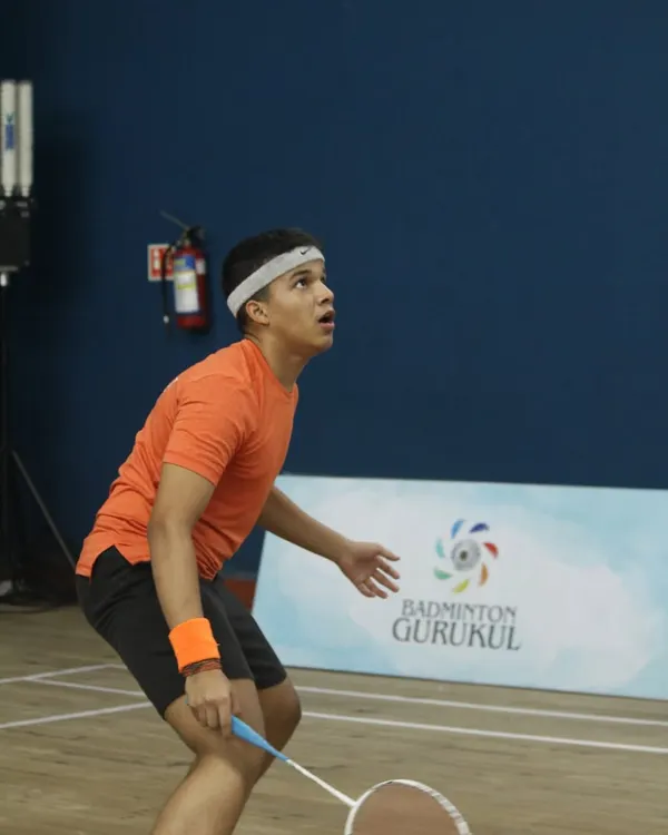 A young player tracks the shuttlecock with intense focus during the Yonex Sunrise Gautam Thakkar Memorial Championship. Our events provide a platform for serious junior competitors to shine.