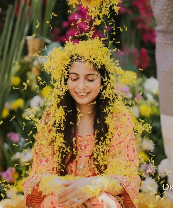 A bride showered in a cascade of marigold petals during her Haldi. I love creating these moments of pure, unscripted joy, set against a backdrop of abundant, traditional florals.