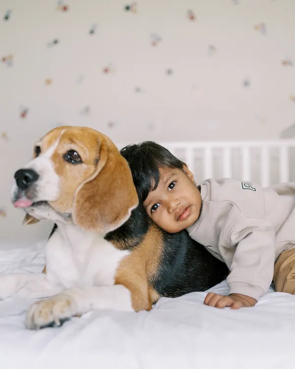 The bond between a boy and his dog is something truly special. This quiet cuddle on the bed is one of my favorite shots, showing a friendship that is pure and unconditional.