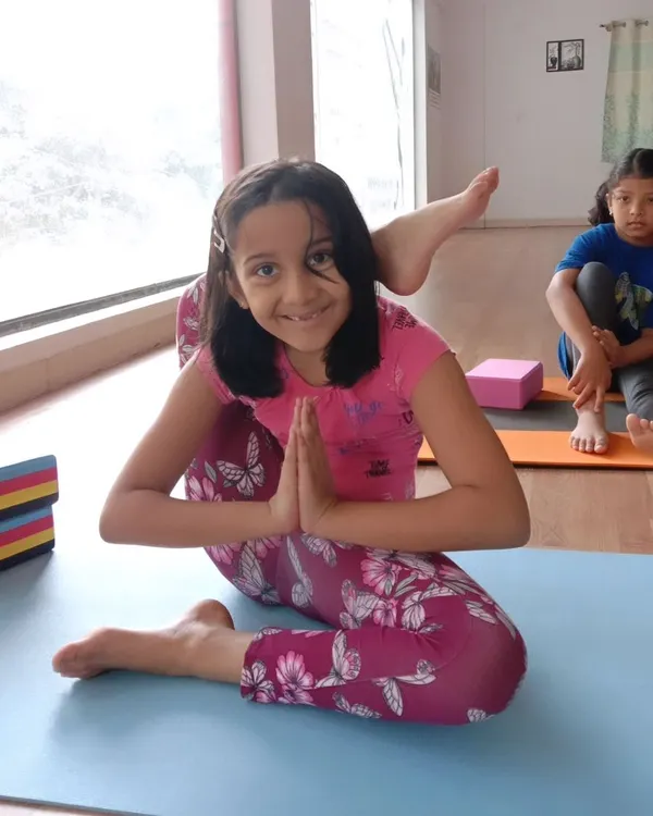 Look at that smile. This young yogi is mastering Eka Pada Sirsasana, or the leg-behind-head pose, with confidence. My goal is to help every child feel proud of their progress, no matter the pose.