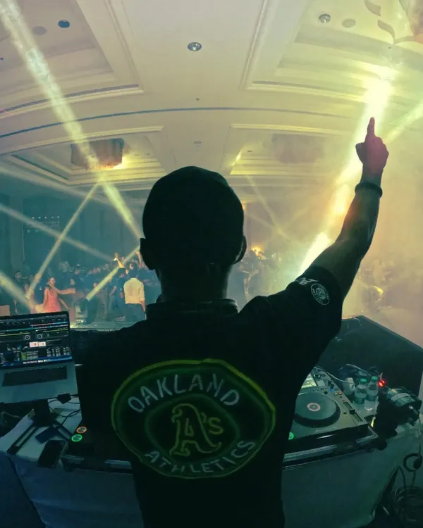 A classic DJ pose from behind the decks, pointing up to the sky. This shot from my March dump captures the feeling of being on top of the world during a great set.