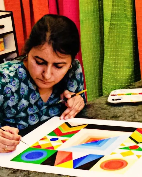 I'm so excited to be restarting my adult art classes! Here, a student is engrossed in a geometric painting, a style that requires precision and a good eye for color.