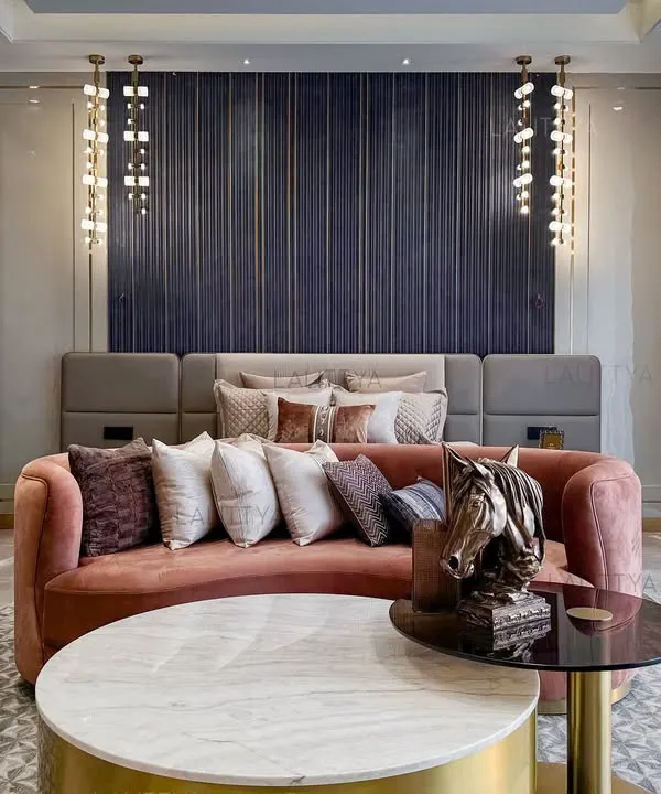 We designed this master bedroom to feel both lived-in and elevated. The fluted, graphite-toned wall serves as a dramatic backdrop for the bed, while a custom curved sofa in a blush fabric adds a soft, inviting touch at the foot.