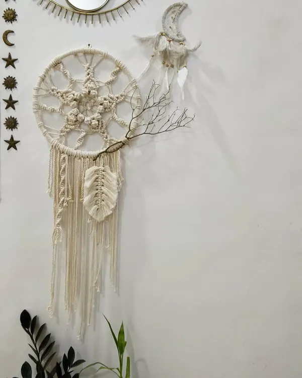 This dreamcatcher-inspired wall hanging brings together intricate macrame knots and a rustic twig accent, perfect for adding a touch of bohemian peace to your home.