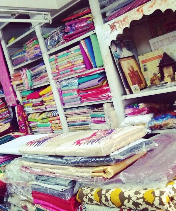 A view of our workshop shelves, stocked with a wide variety of colorful fabrics. You can bring your own material or choose from our collection.