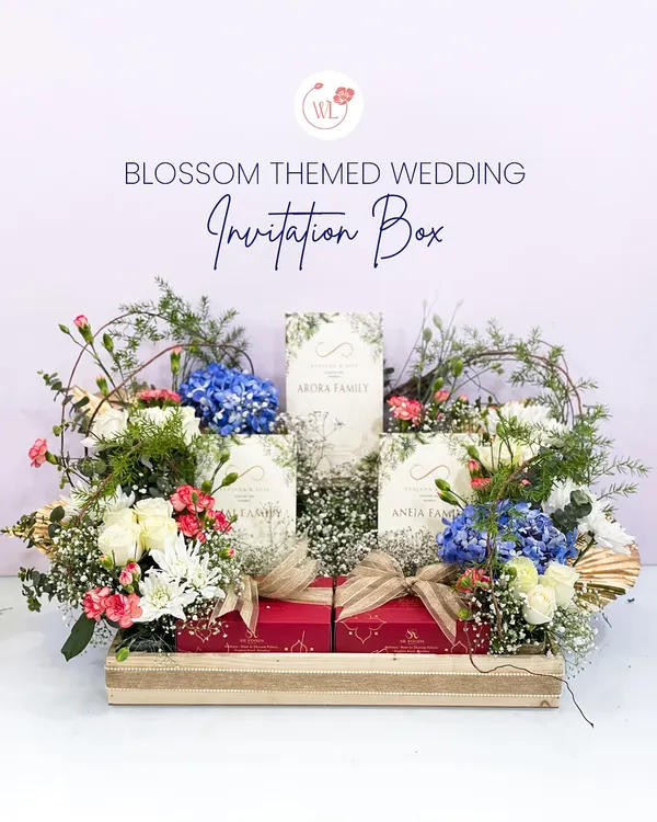 This blossom-themed wedding invitation box is one of my signature creations. It sets a tone of romantic elegance, combining lush florals, personalized invitation cards, and gourmet treats in a stunning wooden tray presentation. This is how we make your first impression unforgettable.