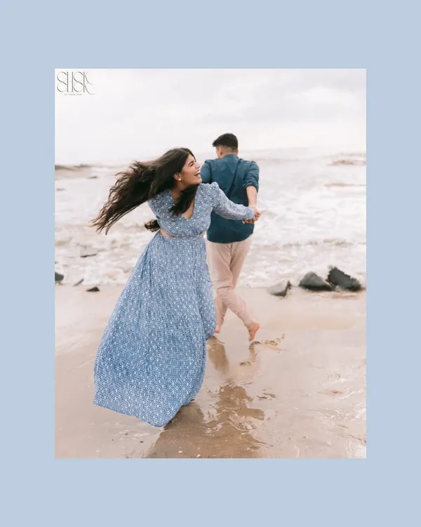 A playful moment on a Goa beach, where her hair dances in the wind as he leads her by the hand. This is the kind of carefree energy that makes beach pre-wedding shoots so special.