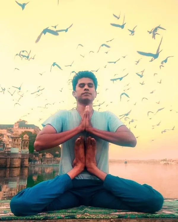 I demonstrate Kandasana by the serene waters of Gangaur Ghat. This advanced posture, named for the bulbous root or 'kanda' where our spiritual energy or Kundalini is said to reside, requires immense flexibility and focus. My practice aims to help you connect with this inner source of power and peace.