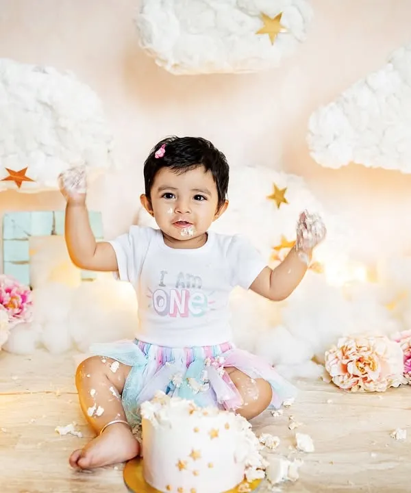 This little one is proud to be one and isn't afraid to get messy. The "I am ONE" shirt and a face full of frosting make for the perfect cake smash photo.