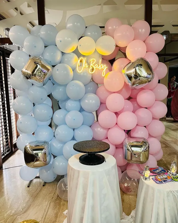 I love creating memorable backdrops for baby showers. This 'Oh Baby' setup features a wall of soft pink and blue balloons, accented with silver cube foils and a bright neon sign, making it the perfect photo spot for the parents-to-be.