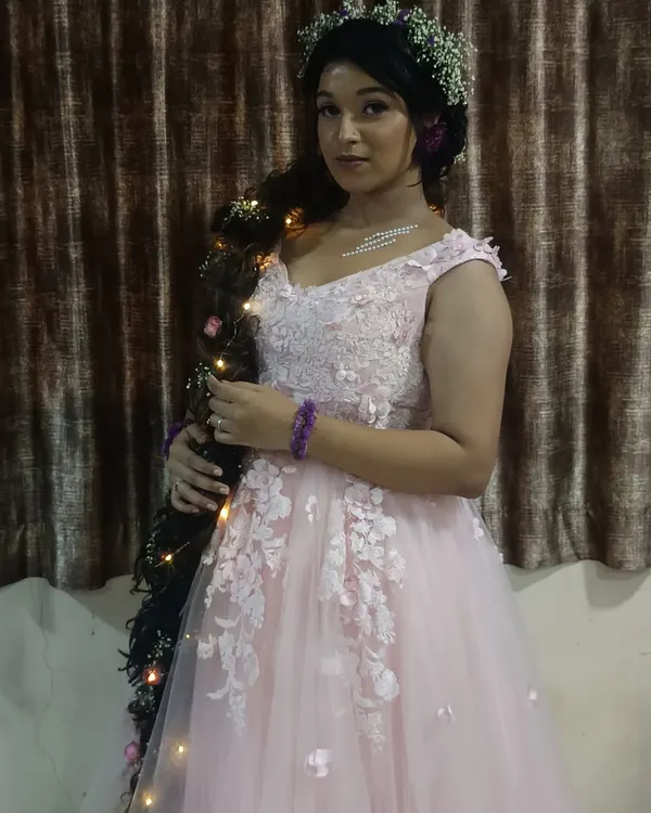 Feel like Rapunzel in this whimsical pink gown, complete with a long, decorated braid. A perfect rental for a fairytale-themed maternity or pre-wedding shoot.