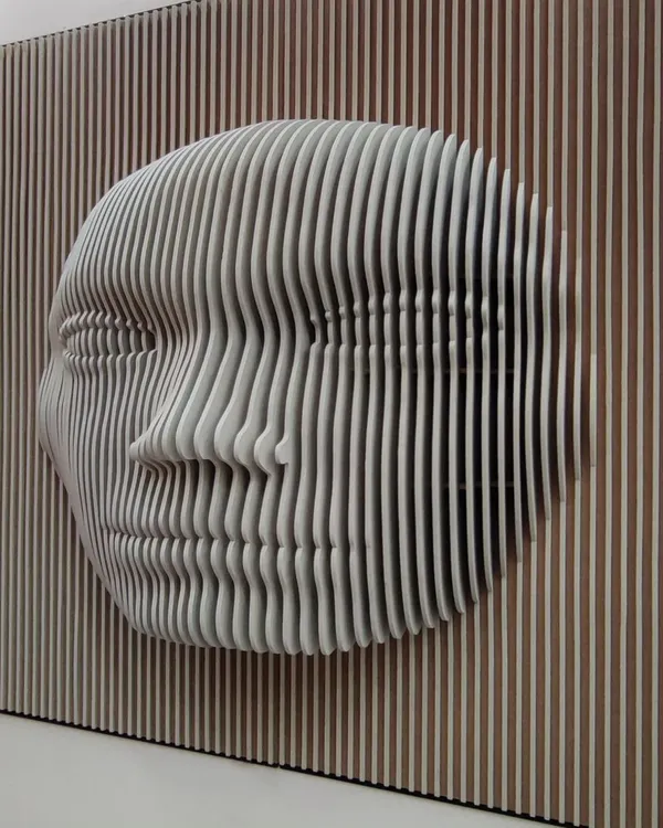 This artistic 3D face sculpture is made from precisely cut MDF panels. It's an example of the custom decorative paneling work I do, which adds a unique visual focus to any space.