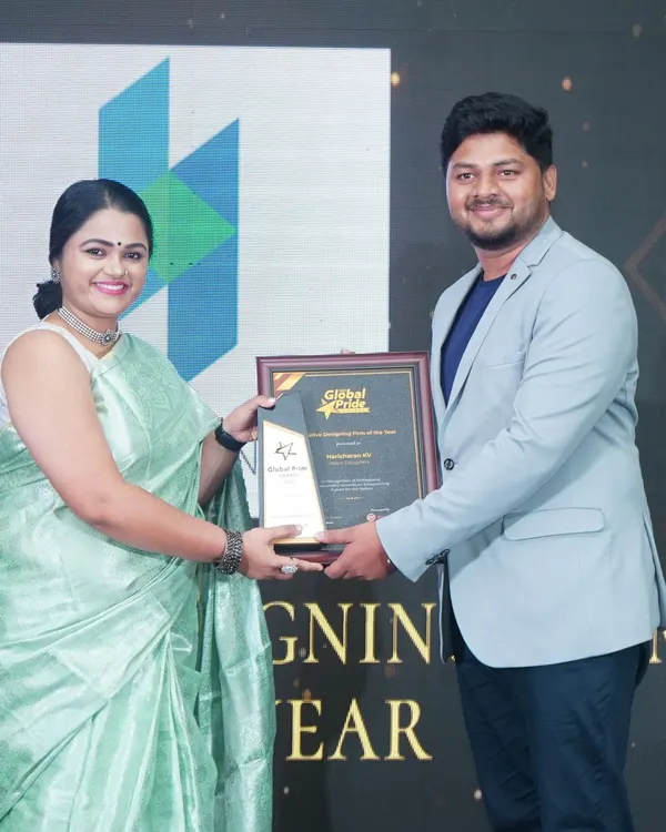 Our founder Haricharan K V accepting the 'Creative Designing Firm of the Year' award on stage. This recognition fuels our passion for delivering exceptional design solutions to every client.