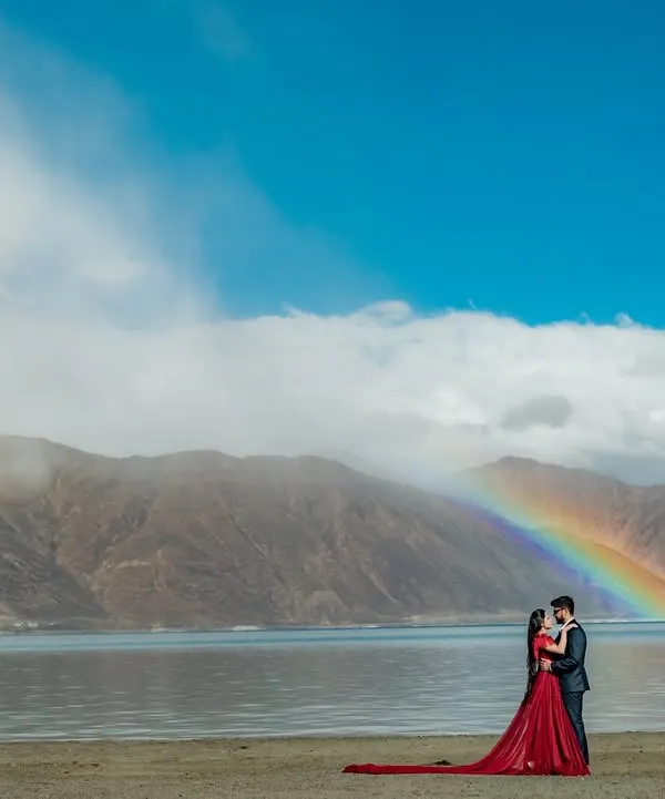 A breathtaking moment for Rishabh and Pooja, framed by the majestic mountains of Ladakh and a surprise rainbow. This is the kind of epic, once-in-a-lifetime shot I strive to capture for every couple.