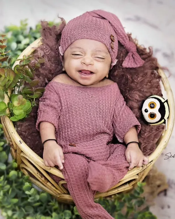 That little smile makes all the patience worth it. Capturing a newborn's fleeting expressions is one of the most satisfying parts of my job.