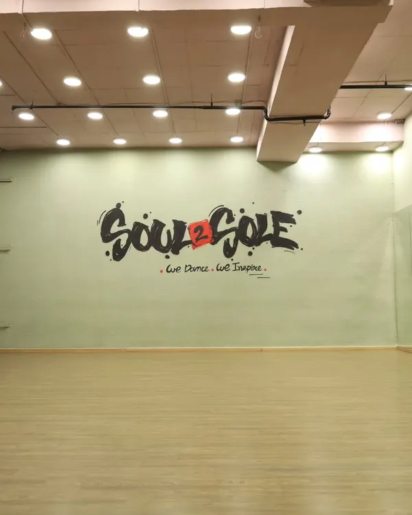 Our main studio space, featuring our signature logo wall. This versatile space is perfect for dance practice, workshops, and photo shoots.
