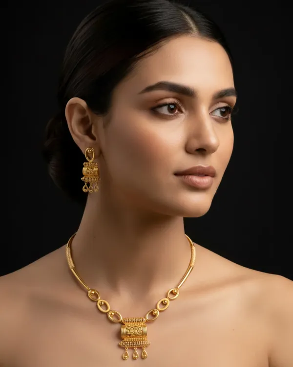 A model wears one of our premium gold necklace and earring sets, showcasing its elegant drape and heritage-inspired design. This piece blends traditional motifs with a modern silhouette, making it a versatile addition for any occasion.