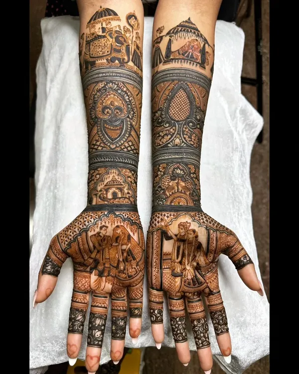 For this South Indian bride, we depicted a classic wedding procession on the forearms, complete with elephants and a doli, while the palms feature a portrait of the couple during the ceremony.