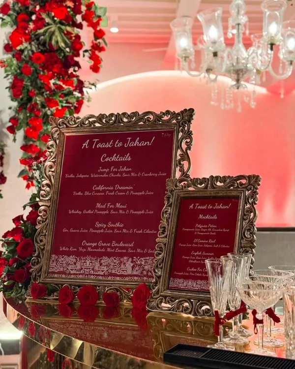 A glimpse into the elegance we bring to every event. This custom bar menu, framed in ornate gold and surrounded by scarlet roses, was the heart of a beautiful Navjote celebration, setting a tone of grandeur and personalized style.