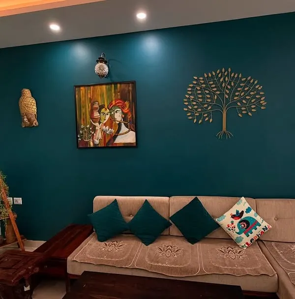 This living room is a great example of how a bold teal accent wall can transform a space. We used a golden tree stencil to add an element of nature and elegance, creating a focal point that is both calming and stylish.