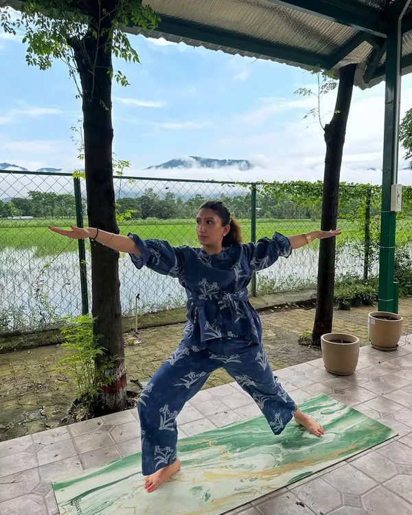 Here I am in the Warrior II pose, feeling grounded and expansive with the mountains and paddy fields as my witness. My retreats are all about finding these moments of connection between your body, your breath, and the incredible nature around us.