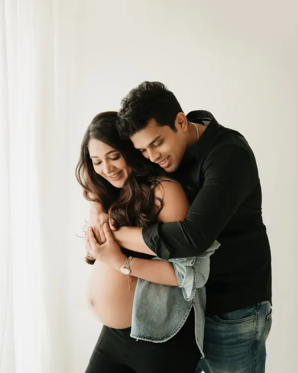 A warm, happy embrace. This is the kind of candid moment I love to capture in a casual couples maternity shoot. It’s all about your genuine connection.