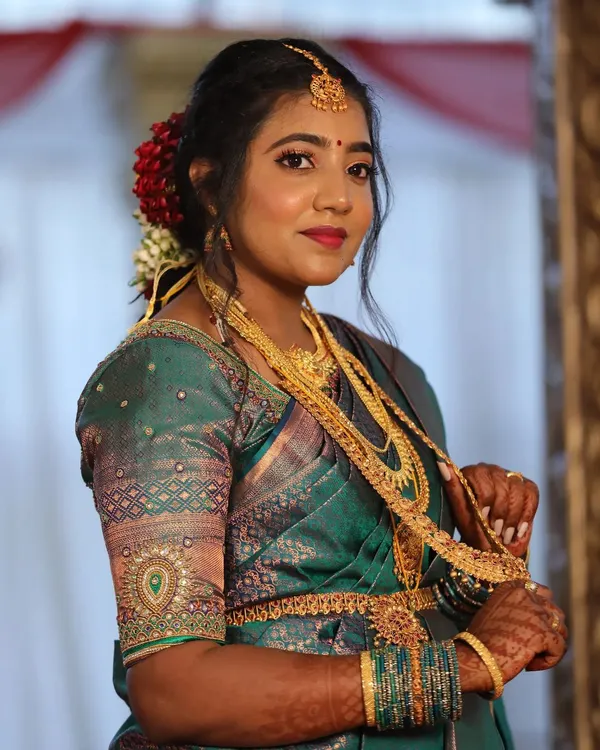 This bride is glowing and ready for her Muhurtham. I enhanced her natural skin tone with a radiant base and paired it with a classic eye and lip that perfectly matches her beautiful teal green Kanjeevaram saree.