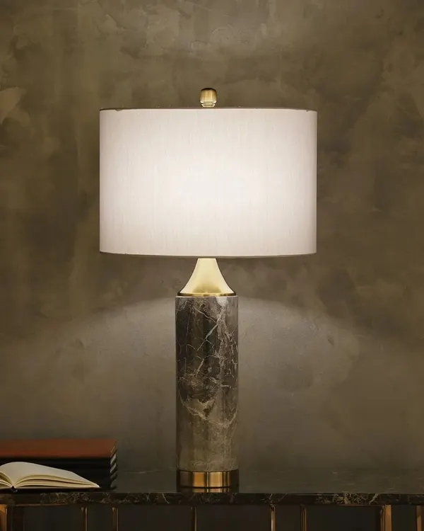 This Mabbina table lamp is built around a pillar of genuine marble, giving it a substantial and luxurious feel. It's a mid-century modern design that brings an element of timeless, natural elegance to any surface.