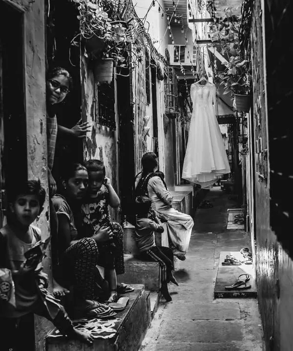 This is the kind of moment I live for. A bride moving through the real, beautiful chaos of her world on her wedding day. This black and white street-style bridal shot captures the authentic story.