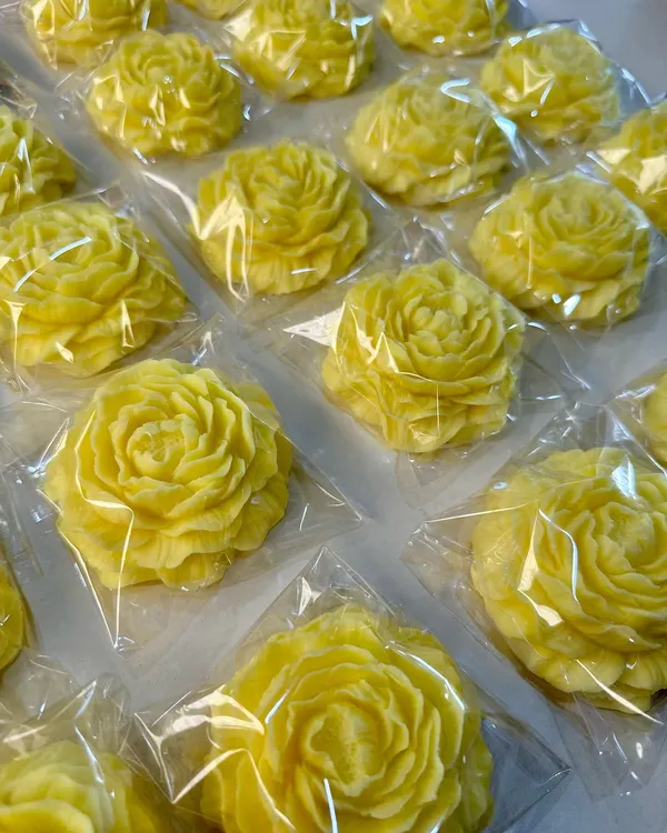 A handcrafted yellow peony soap, created as part of a return gift hamper, bringing a little sunshine to bath time.