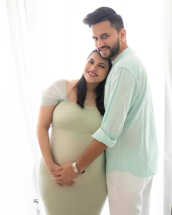 A bright and joyful couple's portrait. Her head resting on his shoulder, this image is filled with the easy, comfortable love between them.