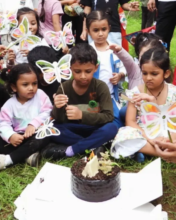 A birthday celebration reimagined. Here, we trade party halls for open fields, celebrating with a nature-themed cake, surrounded by friends and handmade butterfly suncatchers crafted from flowers and leaves found nearby.