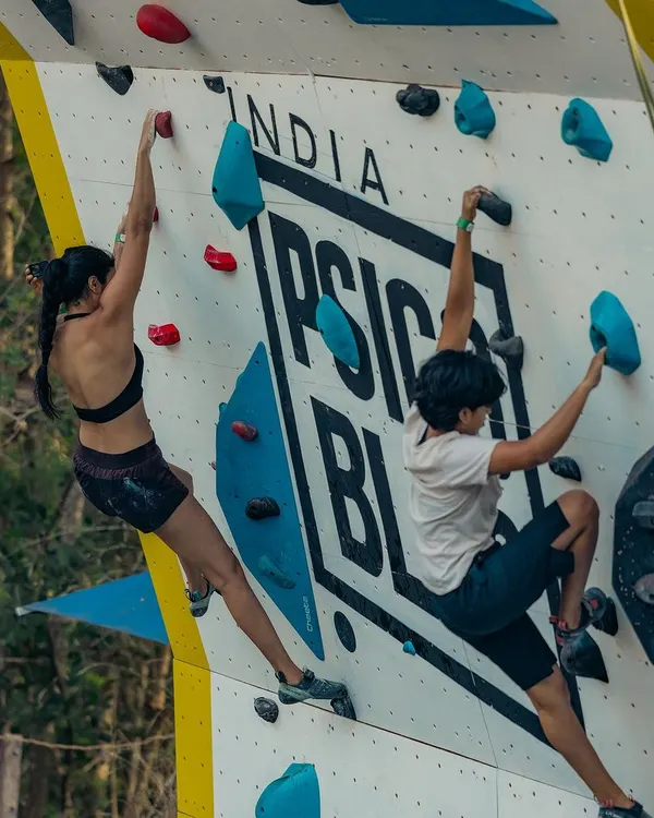 Two climbers go head to head on the Psicobloc wall. You can see the different routes set for the Psico Battle, designed to test both speed and technique.