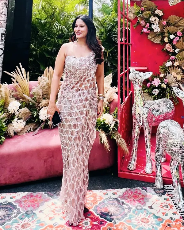 Our signature draped saree dress in sequinned tulle, seen here on a client at an outdoor event. This is the perfect outfit to make heads turn.