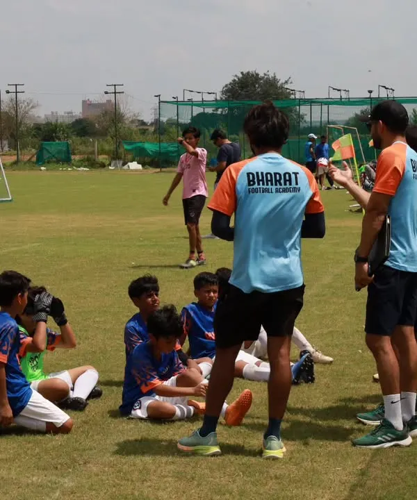Guiding our young warriors on and off the field. A half time talk is a crucial moment for strategy and motivation.