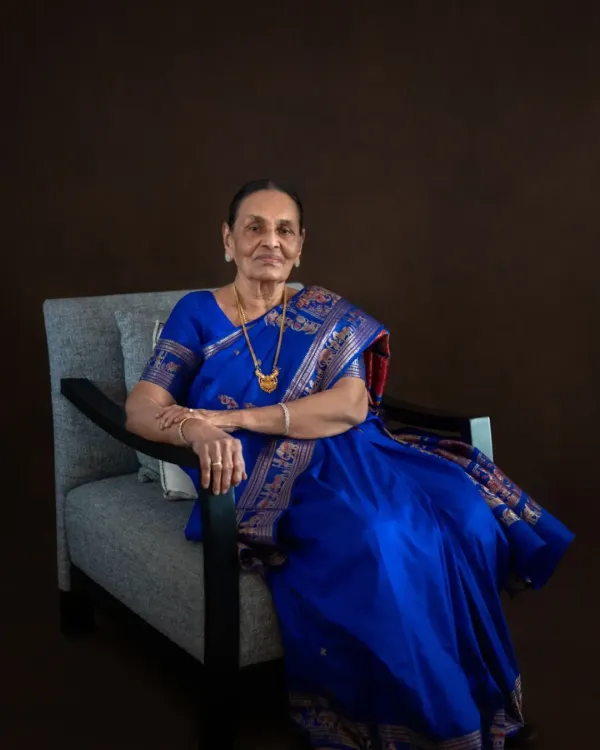 For her 90th birthday portrait session, we captured this elegant seated photo in a stunning royal blue saree. The rich color and her poised demeanor create a regal and timeless image for her family to cherish.