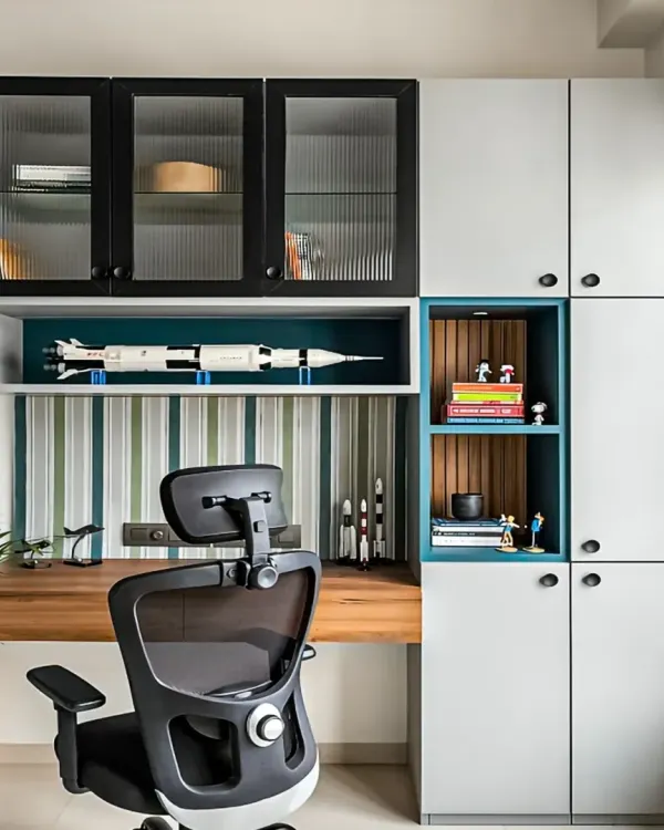 A highly functional study area with floor-to-ceiling cabinets for maximum storage. The design includes a mix of closed and open shelving, with fluted glass doors adding a touch of elegance.