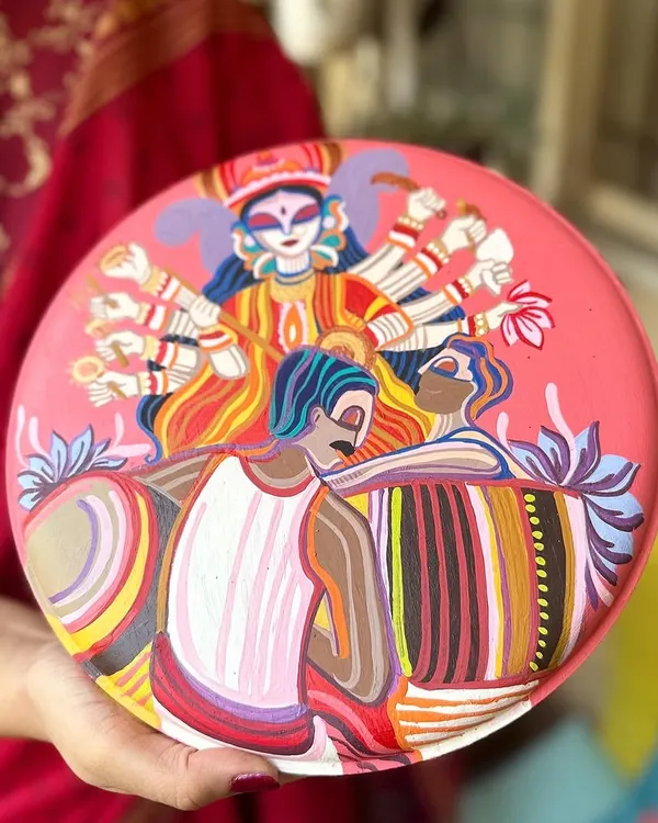 A throwback to a Durga Pujo themed plate we painted for a client. It depicts the goddess Durga along with dhakis, capturing the vibrant energy of the festival.