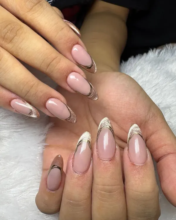An elegant and modern take on the French manicure. This design features a clean, sheer base with a delicate gold and silver double line defining the tip.