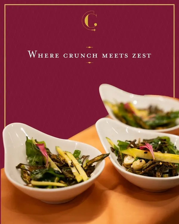 A refreshing salad of crisp-fried okra and julienned raw mango. This dish offers a delightful play of textures and a tangy zest, making it a light and vibrant starter for any occasion.