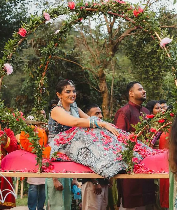 A truly royal entry for our bride, Supreetha. She had always dreamed of a grand entrance, so we designed this beautiful floral palanquin (doli) for her to be carried in like a princess for her Haldi ceremony.