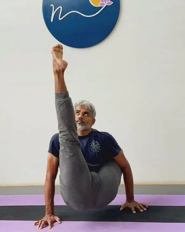 Chakorasana is an advanced arm balance that requires immense core strength, balance, and hip flexibility. It is named after a mythical bird and embodies a sense of lightness and elevation.