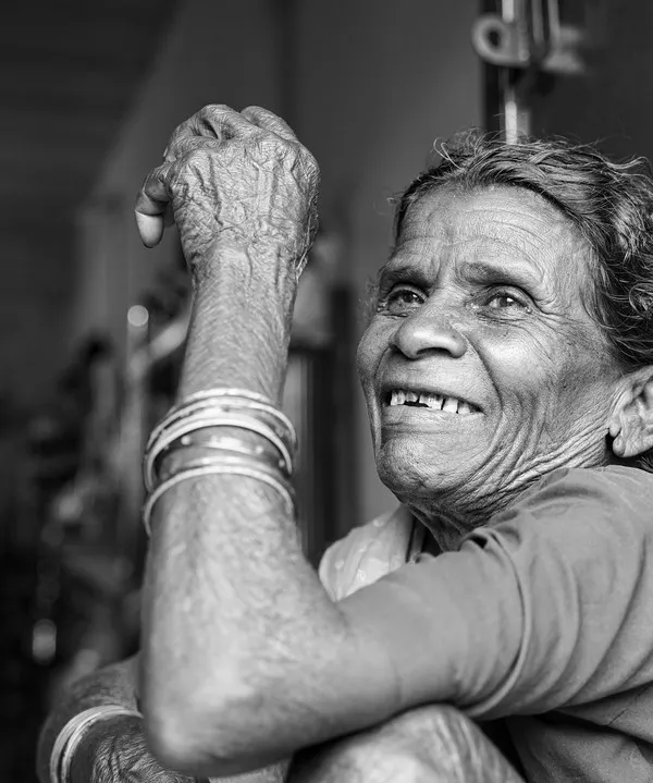 This is the kind of moment I live for. The pure, unscripted joy on this aaji's face after we bought all her flowers was more beautiful than the flowers themselves. This black and white portrait captures the story of her hard work and the simple happiness that followed.