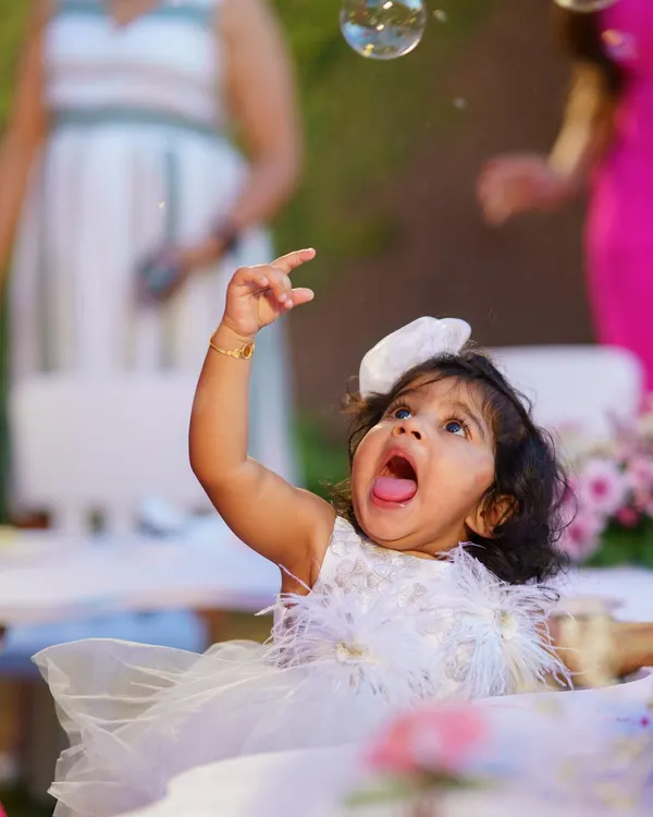 There is nothing more magical than a child's wonder. We live for these unscripted moments of pure joy, like this little one completely fascinated by bubbles. It is these fleeting expressions that turn a simple photograph into a cherished family memory.