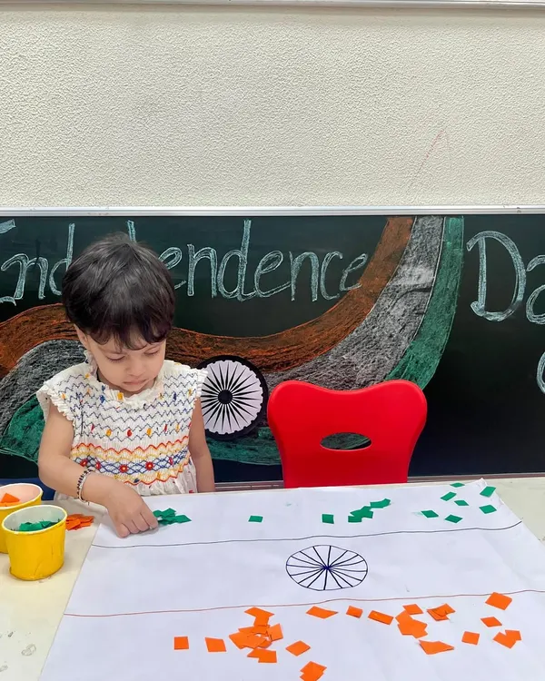 A little patriot carefully creates the Indian flag using pieces of colored paper. This Independence Day activity helps foster a sense of national pride while developing fine motor skills.