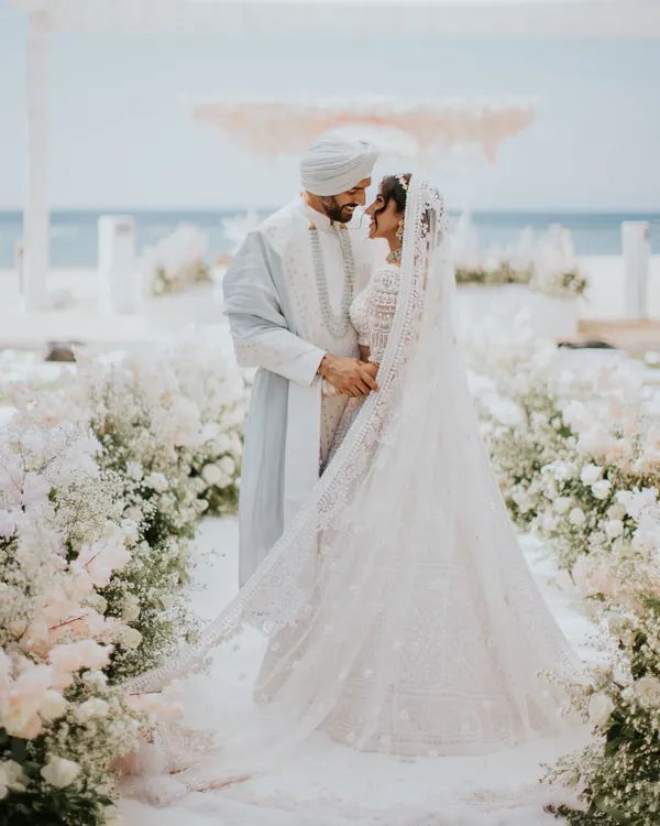 This is what dream destination weddings are made of. I styled Munpreet and Manish for their breathtaking Bali wedding, creating a look that was as magical as the setting. She is in a stunning ivory Manish Malhotra lehenga, and he is in a custom ice blue Anita Dongre sherwani.