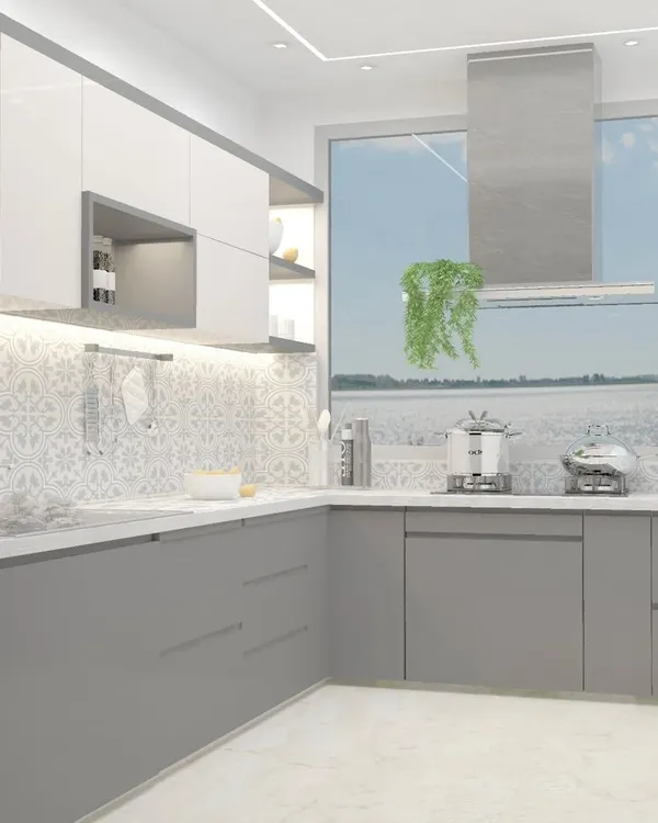 This bright and airy kitchen features two-tone cabinets in grey and white, with a patterned tile backsplash that adds personality. The large window provides ample natural light, making the space feel open and welcoming.