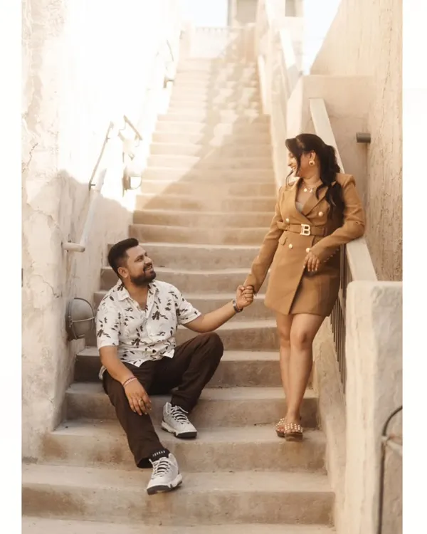 A romantic moment on a rustic staircase in Old Dubai. The warm, earthy tones and historic architecture provide a beautiful and unique backdrop for a pre-wedding shoot.