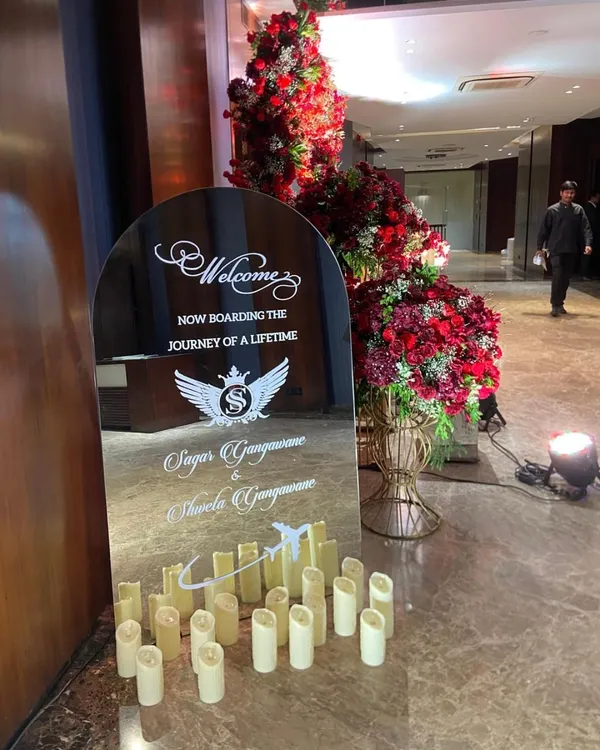 A personalized welcome sign on a mirror, with a clever "Now boarding the journey of a lifetime" message for a couple connected to aviation.