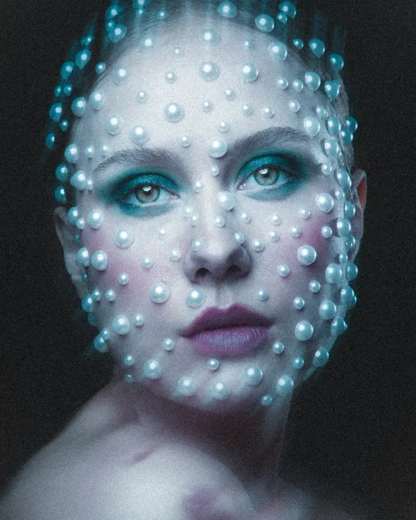 This celestial-inspired look is one of my absolute favorites. I meticulously applied each pearl to create a textural, otherworldly effect, pairing it with a soft teal eyeshadow and a muted lip to let the pearlwork shine. This is the kind of avant-garde makeup I love to create for conceptual shoots.